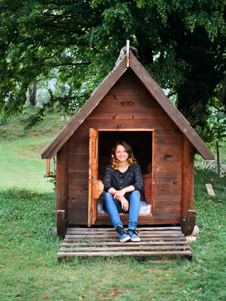 girl sitting tiny house